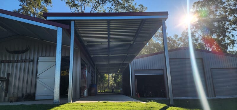 Completed shed and carport structure joining an existing building